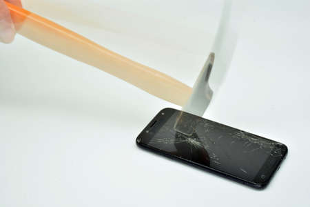Mobile phone screen hit by a hammerの写真素材
