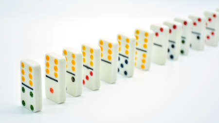 Colored dominoes put in a row, domino effectの写真素材
