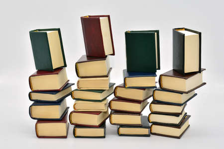 Books stacked in different ways, isolated with white backgroundの写真素材
