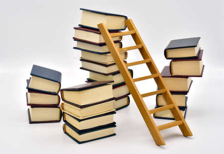 Books stacked in different ways, isolated with white backgroundの写真素材