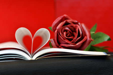 Pages of a book curved in the shape of a heartの写真素材