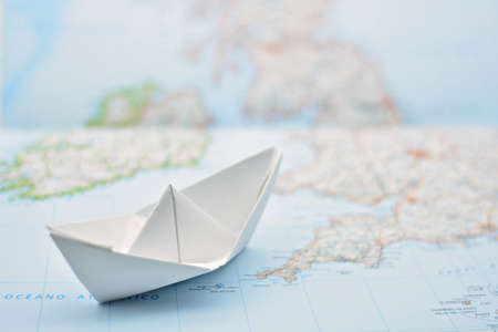 Paper boat on the water painted from a blurred mapの写真素材