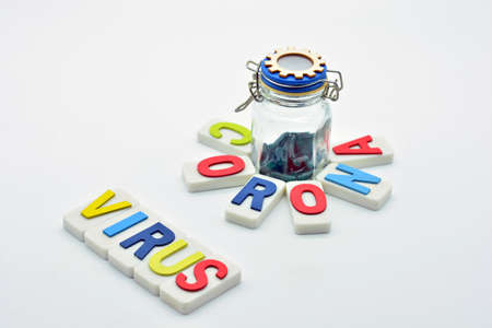 The word coronavirus and a bottle of pills on a white backgroundの写真素材