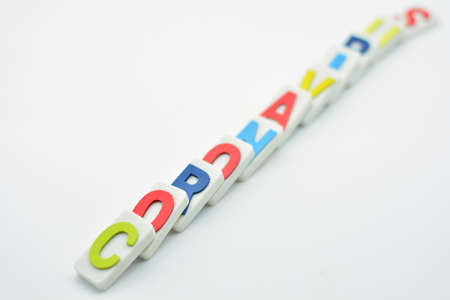 Falling dominoes with the word coronavirus, domino effectの写真素材