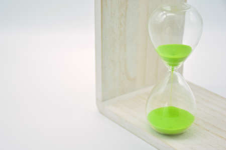 Hourglass, with green sand, arranged in different waysの写真素材