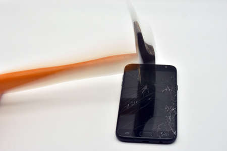 Hammer hitting mobile phone screenの写真素材