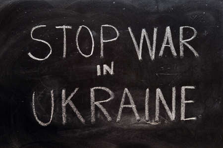 Stop war in Ukraine, handwritten with a chalk on the blackboardの写真素材