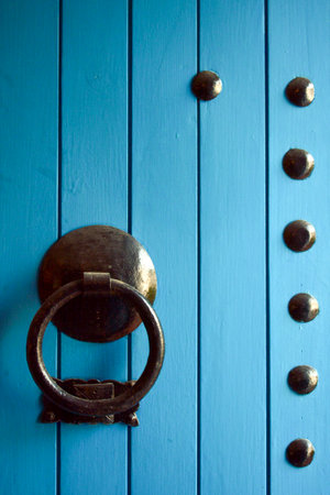Detail of a wooden door painted in turquoise blueの写真素材