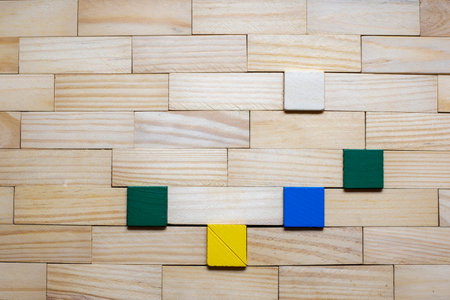 Wall made with wooden blocks and colored square dowels