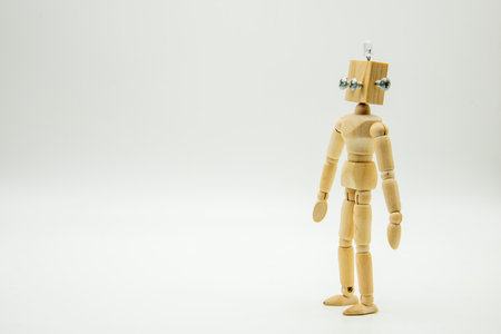 Small original mannequin robot, made with wood and screws, isolated on whiteの写真素材