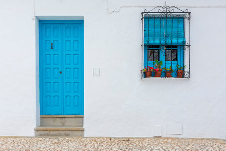 Typical village facade with blue door and windowの写真素材