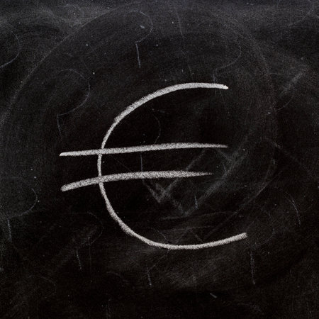 euro symbol painted on a blackboard with chalkの写真素材