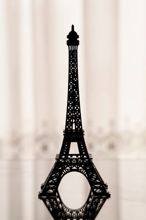 Backlit silhouette of a miniature Eiffel Towerの写真素材