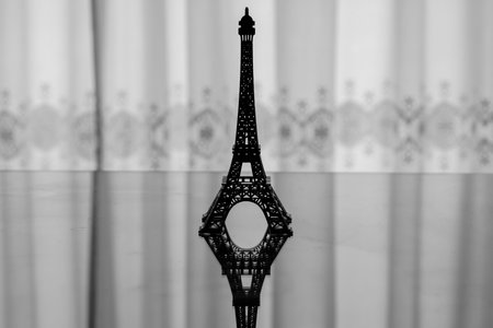 Backlit silhouette of a miniature Eiffel Towerの写真素材