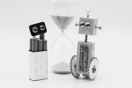 Small robot with wheels, made with wood and screws, and a stack of disassembled flask, isolated on...
