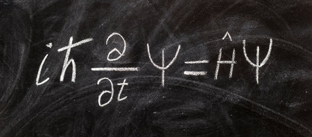 SchrÃ¶dinger wave equation handwritten with chalk on blackboard, quantum physics