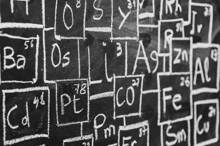 Periodic table of chemistry elements handwritten with chalk on blackboardの写真素材