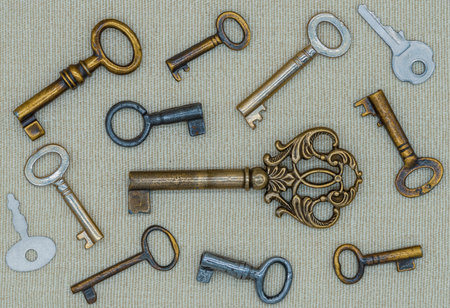 Several old metal keys on a linen mat
