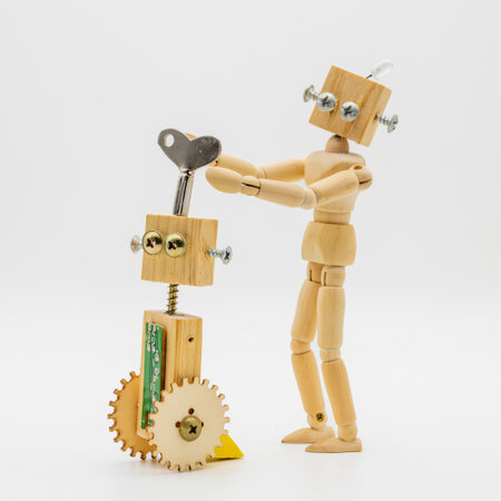 Small robots made with wood and screws turning winding wrench, isolated on white