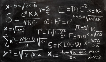 Mathematical equations and physics formulas handwritten with chalk on blackboardの写真素材