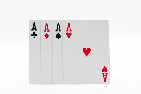 Cards from a deck forming a poker of aces, isolated on white