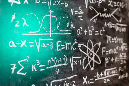 Mathematical operations and quantum physics formulas handwritten with chalk on the blackboardの写真素材