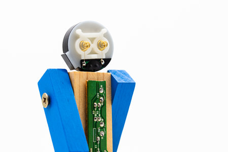 Small robot made with wood, screws and parts of electronic parts, isolated on whiteの写真素材
