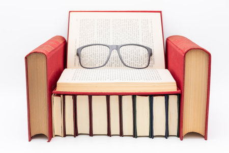 Sofa made of books and glasses on itの写真素材