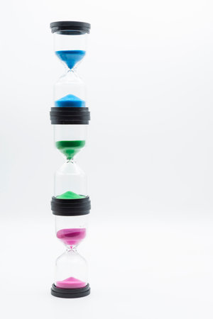 Trio of hourglasses in different colors, isolated on whiteの写真素材