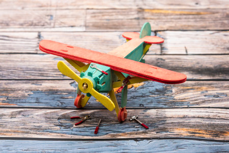 Wooden airplane being repaired with hand toolsの写真素材