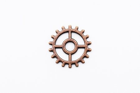 Metal gear wheel made of copper and bronze, isolated on white