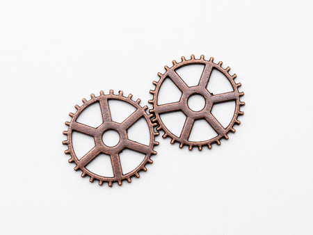 Metal gear wheels made of copper and bronze of different sizes, isolated on white