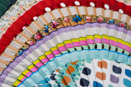 Traditional Spanish open wooden fans, painted with different motifs and colorsの写真素材