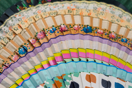 Traditional Spanish open wooden fans, painted with different motifs and colorsの写真素材