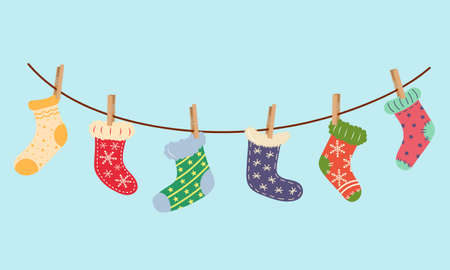 Christmas socks hanging on laundry string with clothespins. Socks season collection.のイラスト素材