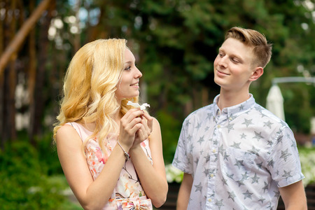 Man breaks a flower and give to his girlfriendの写真素材