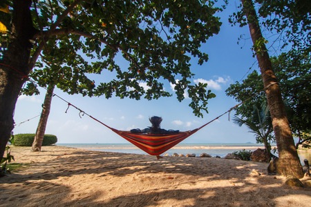 Girl in hammock on the tropical beachの写真素材