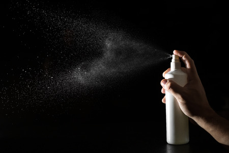 Spray bottle on bleck backgroundの写真素材