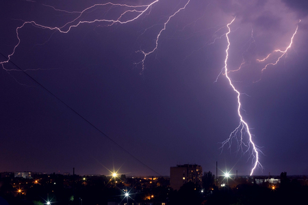 Lightning storm over the city in purple light