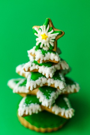 Christmas tree gingerbread on green background.の写真素材