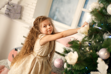 Cute little princess decorate christmas tree. Holidays concept.の写真素材