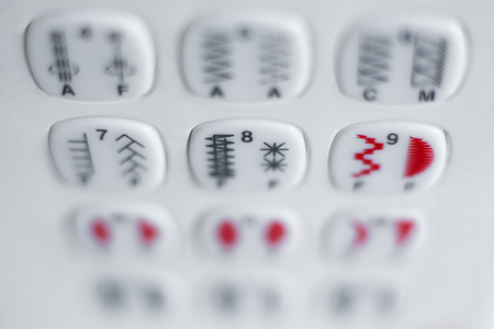 A set of buttons to select the type of stitching on the sewing machine. Sewing industry.の写真素材
