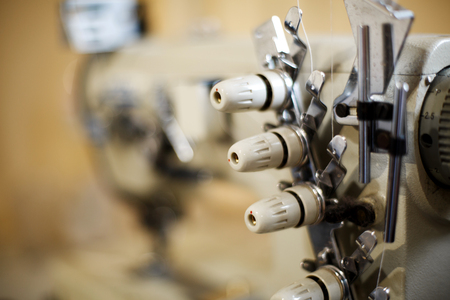 closeup details on sewing machine overlock. Workplace seamstress.Tailoring industry.の写真素材