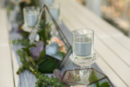 Florarium with fresh succulent and rose flowers festive table decoration. Event fresh flowers decoration. Florist workflow. Wedding ceremony  designの写真素材