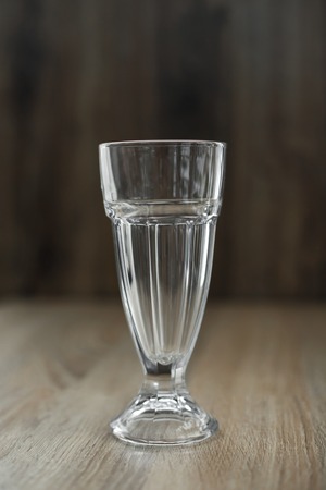 Prepare a delicious hot vitamin drink on a cold winter day. Empty glass tumbler on a wooden table.の写真素材