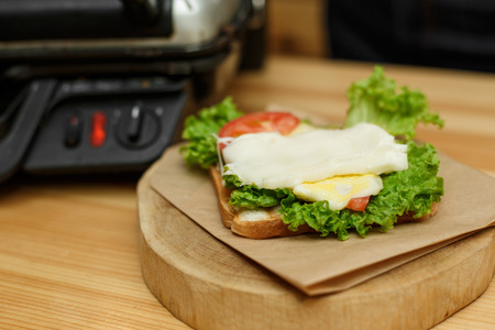 put the melted cheese in a sandwich. cooking juicy sandwich.の写真素材