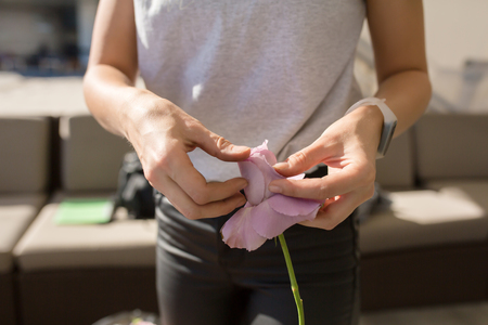 Closeup  florist girl prepares fresh flowers to decorate the event. Wedding florist arranges workflow.の写真素材