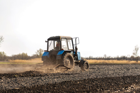 a tractor plows a field for sowing crops.の写真素材