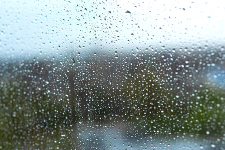 raindrops on the glass on the background of nature.