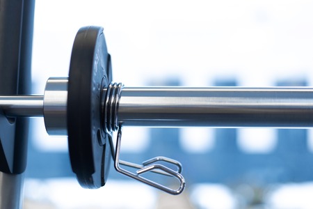 Closeup weight plate fixed on barbell in gym.の写真素材